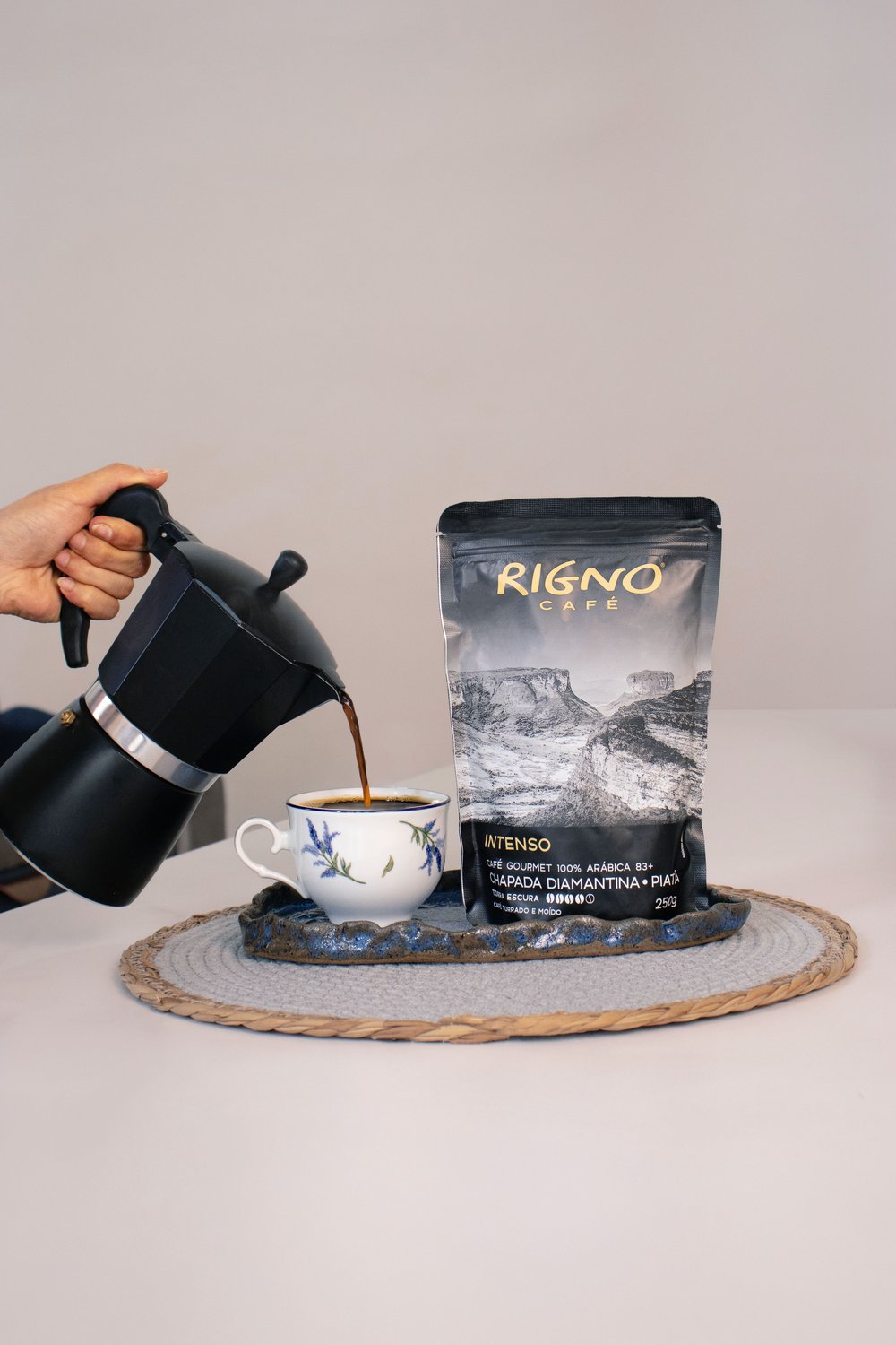 Café Rigno sendo coado em xícara, ao lado do pacote da marca, produzido em Piatã, Chapada Diamantina